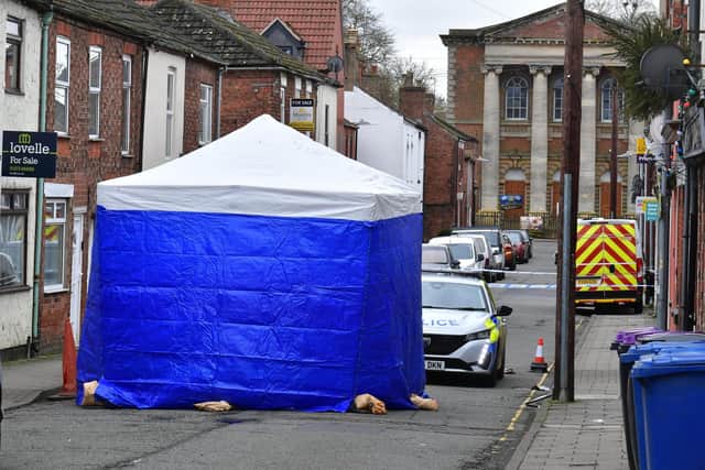 Investigators and a police cordon at the scene of the fatal stabbing on Union Street, Market Rasen. Photo: David Dawson