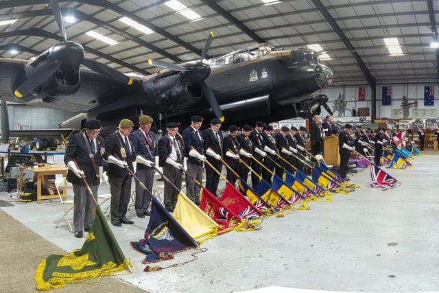 Bearers with standards lowered in respect.