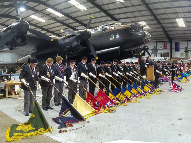 Bearers with standards lowered in respect.