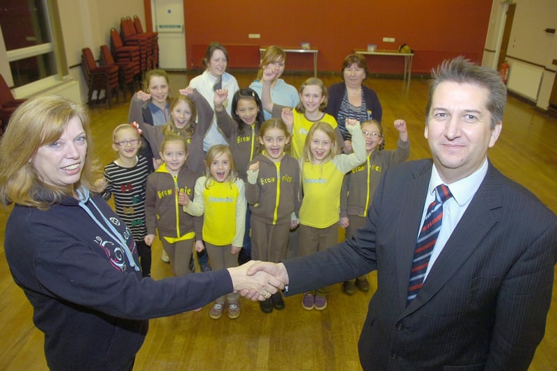 The 3rd Cranwell Brownies receiving £300 from solicitors Sills and Betteridge to help meet running costs. Pictured are Anne Riddington, Brown Owl, and Andrew Goldborough, of Sills and Betteridge.