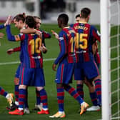 Lionel Messi celebrates with teammates after scoring for Barcelona against Real Betis. (Photo by Eric Alonso/Getty Images)