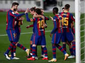 Lionel Messi celebrates with teammates after scoring for Barcelona against Real Betis. (Photo by Eric Alonso/Getty Images)