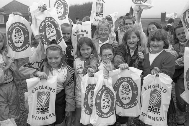 Youngsters with bags marking England's double grand slam of 1991 and 1992 and Rugby World Cup Sevens triumph of 1993.