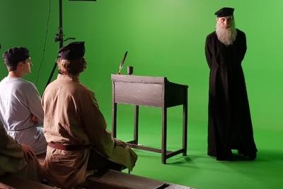 The actors run through their lines and warm-up for filming on set.