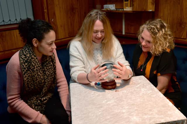 Tanya Mitchell, Donna Short, and Nicola Anderson try out the crystal ball.