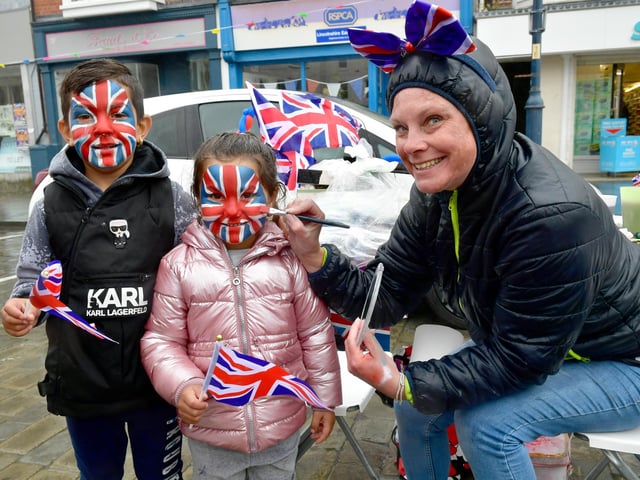 Party in the Market Place: Sergaiy Momchilova, aged six, and Zoya Momchilova, aged four, having their face painted by Eve-Marie Price.