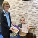 Grinchmas Scavenger Hunt winner Paul Walters received his prize from staff member Liz Wood.