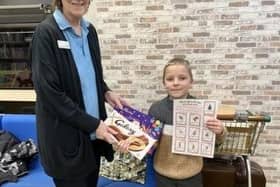Grinchmas Scavenger Hunt winner Paul Walters received his prize from staff member Liz Wood.