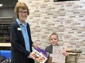 Grinchmas Scavenger Hunt winner Paul Walters received his prize from staff member Liz Wood.