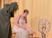 Sleeping Beauty and Bad Witch Hazel disguised as an old lady, coaxing her to spin some wool.