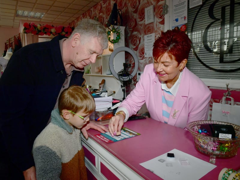 Dave Parry and Tommy Brown 5 doing the Easter Trail, getting a stamp from Wendy Hanslip of Bellissimo Boutique. Photo: David Dawson