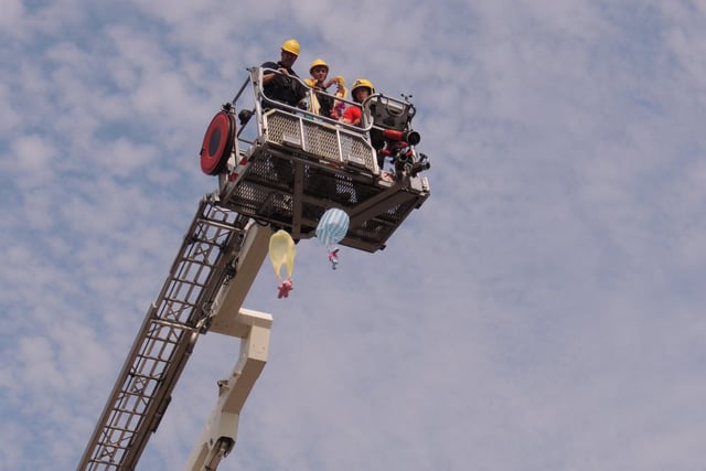 Parachuting teddy bears from the aerial ladder platform at the fire and ambulance station open day in Sleaford.