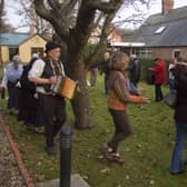 Wassailing around the Apple tree in the museum garden at a previous Christmas Event.