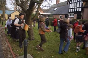 Wassailing around the Apple tree in the museum garden at a previous Christmas Event.