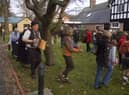 Wassailing around the Apple tree in the museum garden at a previous Christmas Event.