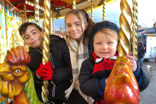 Teddy, Rosalie and Daniel enjoy the Galloper's fairground ride at Wainfleet's Festive Fabuloso.