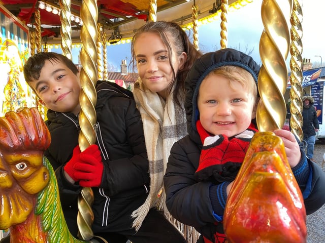 Teddy, Rosalie and Daniel enjoy the Galloper's fairground ride at Wainfleet's Festive Fabuloso.