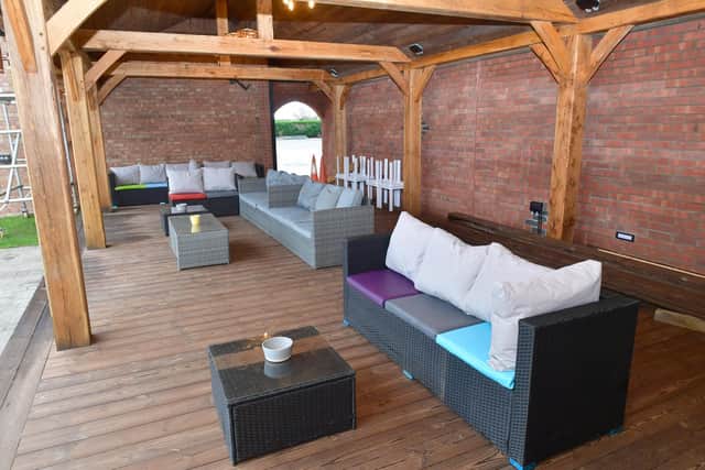 A covered seating area beside the pool.