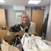 Karen Elliott at William Alvey School, Sleaford accepting the 30-or-so pairs of shoes on behalf of the school, which will be polished and boxed up for donation to families in need. Photo: NKDC