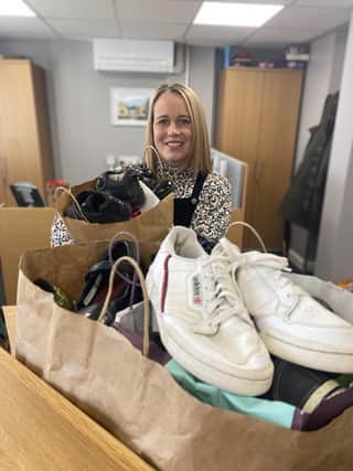 Karen Elliott at William Alvey School, Sleaford accepting the 30-or-so pairs of shoes on behalf of the school, which will be polished and boxed up for donation to families in need. Photo: NKDC
