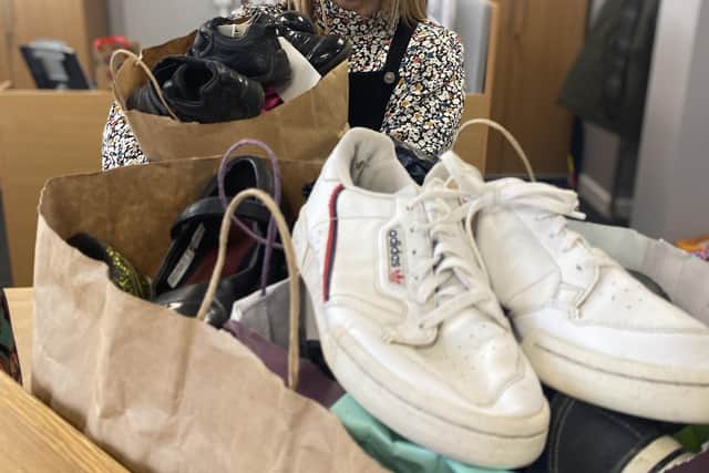 Karen Elliott at William Alvey School, Sleaford accepting the 30-or-so pairs of shoes on behalf of the school, which will be polished and boxed up for donation to families in need. Photo: NKDC
