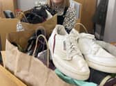 Karen Elliott at William Alvey School, Sleaford accepting the 30-or-so pairs of shoes on behalf of the school, which will be polished and boxed up for donation to families in need. Photo: NKDC