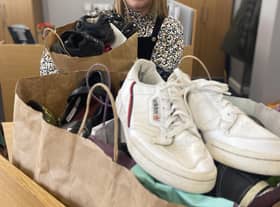 Karen Elliott at William Alvey School, Sleaford accepting the 30-or-so pairs of shoes on behalf of the school, which will be polished and boxed up for donation to families in need. Photo: NKDC