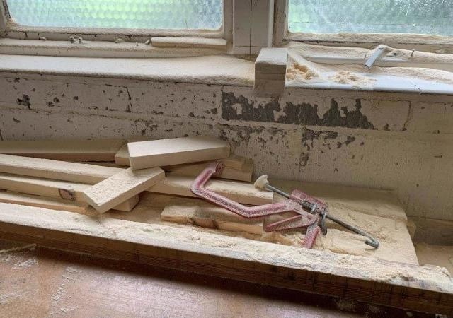 Wood dust coating a bench and windowsill at The Furniture Chest workshop. Photo: HSE