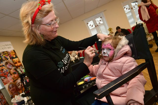 Hannah Broughton 2 having her face painted by Felicity Sayers in the Town Hall.