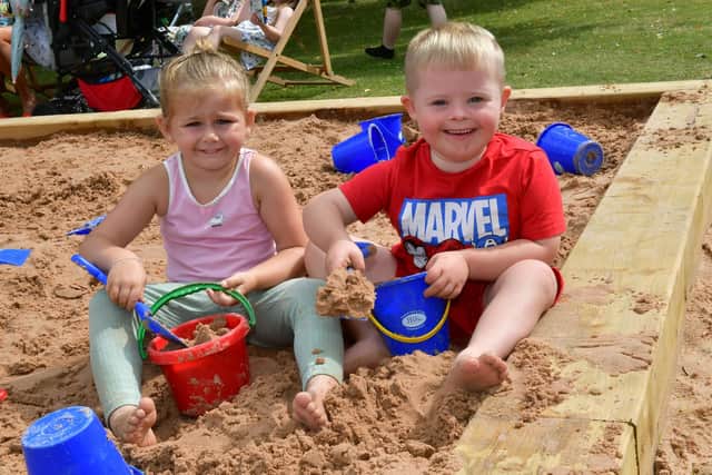 Camirah Borman, aged four, and Archie Carlon, aged five, of Boston play in the sand.