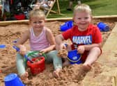 Camirah Borman, aged four, and Archie Carlon, aged five, of Boston play in the sand.