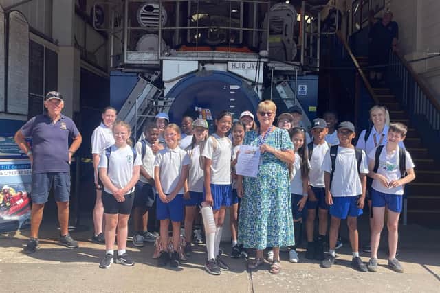 Year 6 children from Our Lady of Good Counsel RC School present their fundraising donation to the RNLI lifeguards at Skegness.