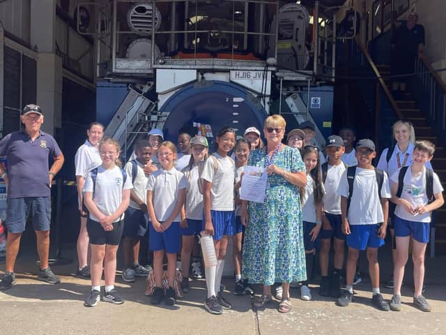 Year 6 children from Our Lady of Good Counsel RC School present their fundraising donation to the RNLI lifeguards at Skegness.