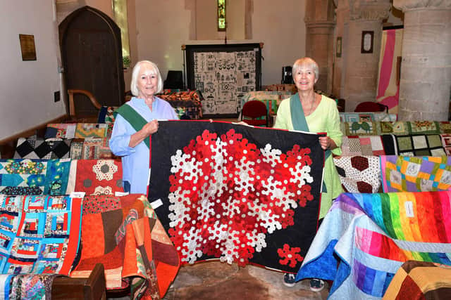 From left - Lorna Bushnell and Annabel Groom show off quilts on display at Cranwell church. Photo: Mick Fox
