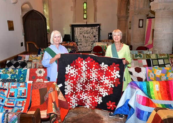 From left - Lorna Bushnell and Annabel Groom show off quilts on display at Cranwell church. Photo: Mick Fox
