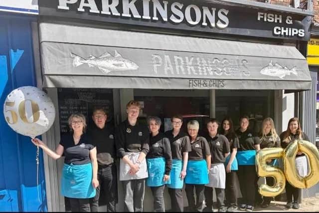 Co-owners Sharon and Marcus Foster celebrate the 50th anniversary with staff members at Parkinson's fish and chip shop in Louth.