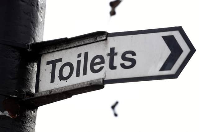 A sign for public toilets in London. Spending by councils in England on basic services such as public toilets, road safety and pest control has fallen as much as 40\% since 2010.