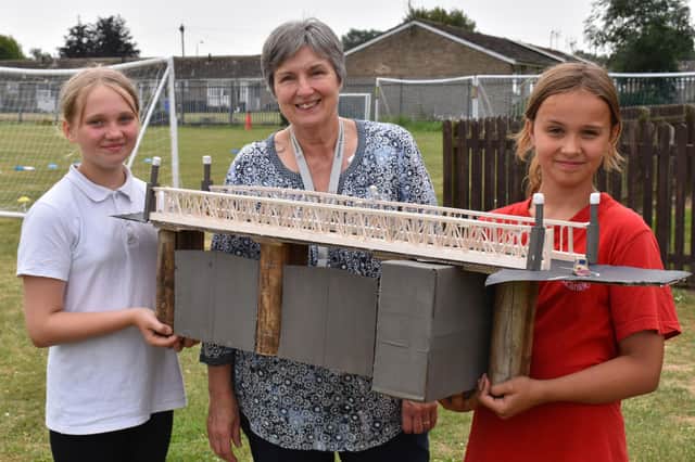 Pupils and a staff member with their scale model of Sluice Bridge.