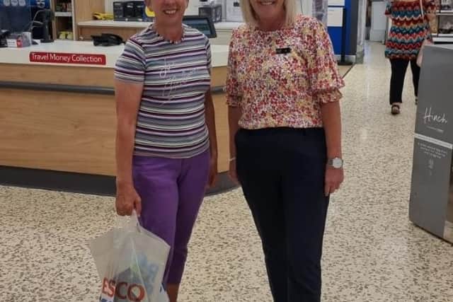 Hilary Wilkinson (left) of the Never Forgotten Club receives the donation.