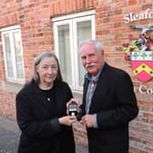 New Mayor Coun Anthony Brand, presents a past mayor's badge to outgoing Mayor Coun Linda Edwards-Shea.