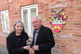 New Mayor Coun Anthony Brand, presents a past mayor's badge to outgoing Mayor Coun Linda Edwards-Shea.