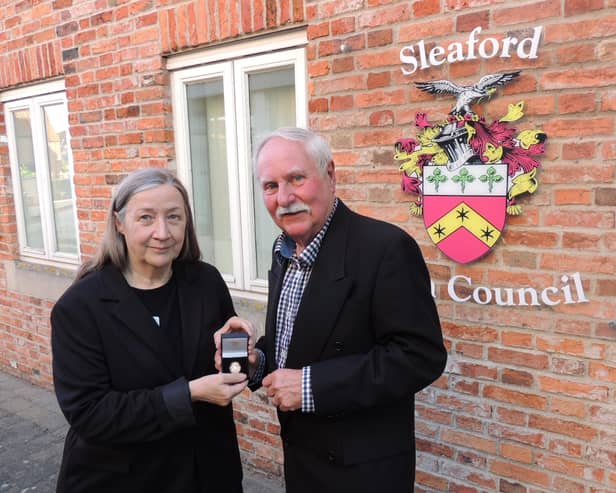 New Mayor Coun Anthony Brand, presents a past mayor's badge to outgoing Mayor Coun Linda Edwards-Shea.