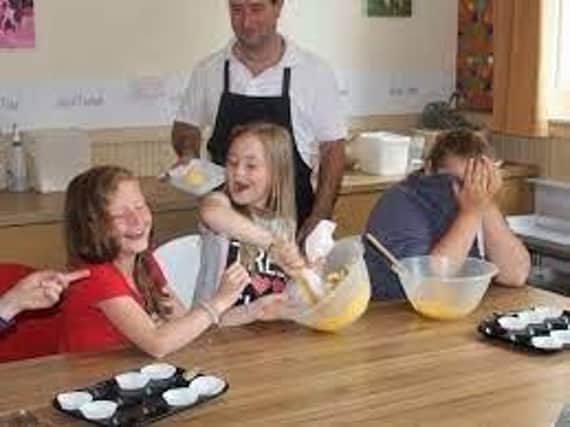 Youngsters helping prepare food at Derbyshire Children's Holiday Centre in Skegness.