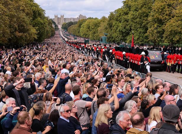 <p>Mourners watch the State Hearse of Queen Elizabeth II as it drives along the Long Walk ahead of the Committal Service for Queen Elizabeth II in Windsor (Photo by Richard Heathcote/Getty Images)</p>