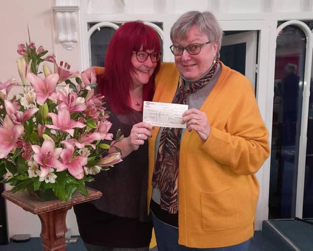 Rebecca Harris from Barnardo’s (left) and Audrey Moore from Eastgate Union Church smile as the cheque is handed over