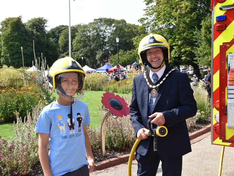 Mayor of Skegness Coun Jimmy Brookes has fun with a young 'recruit' at the Skegness Fire and Rescue engine.