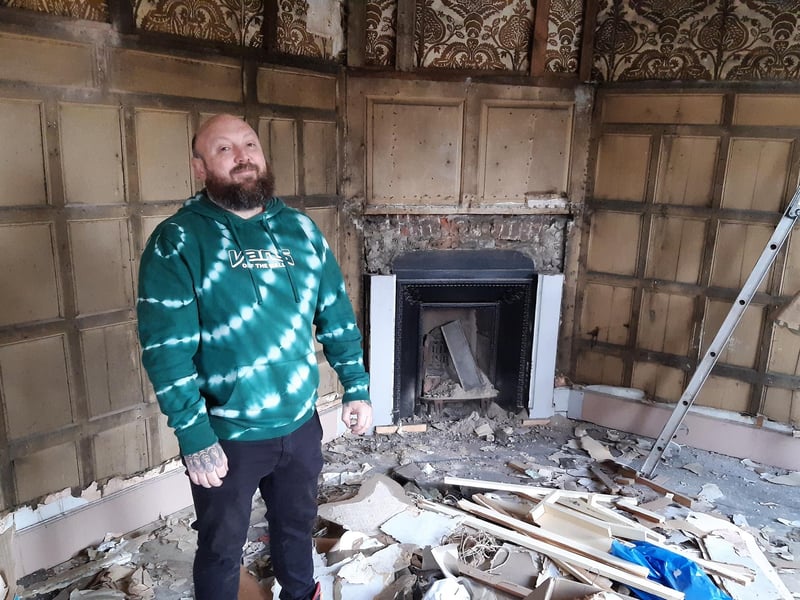 Shane Gostelow, of Boston, peeling back the history in the former A. Cheer and Sons building in Boston.