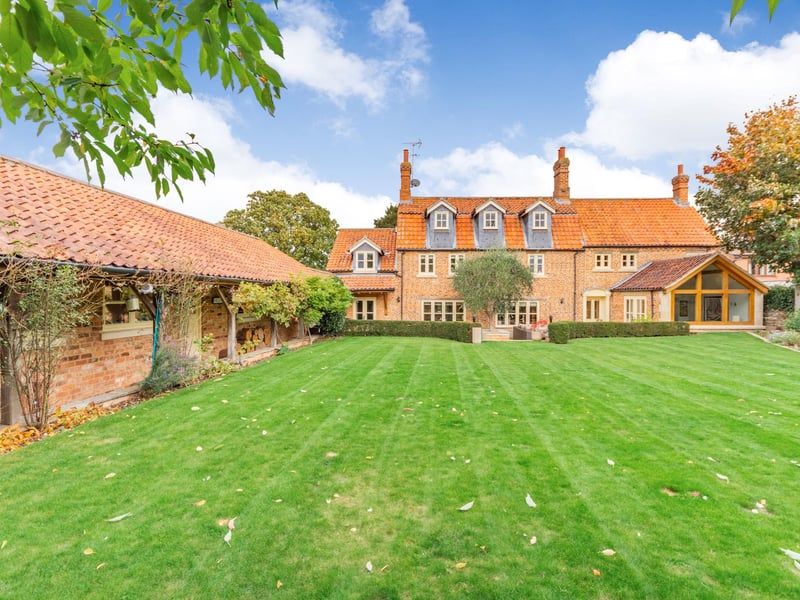 The rear of the home, the garden, and the garaging.