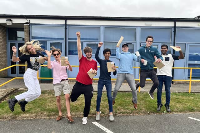 QEGS Horncastle A levels students jumping for joy, from left: Grace Lunn, Max Booth, Sam Reece, Dhruv Gongireddy, Alfie Parfitt, Anthony Stanton and Duvindu Pathirathna.