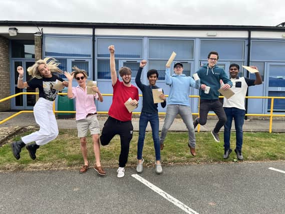 QEGS Horncastle A levels students jumping for joy, from left: Grace Lunn, Max Booth, Sam Reece, Dhruv Gongireddy, Alfie Parfitt, Anthony Stanton and Duvindu Pathirathna.